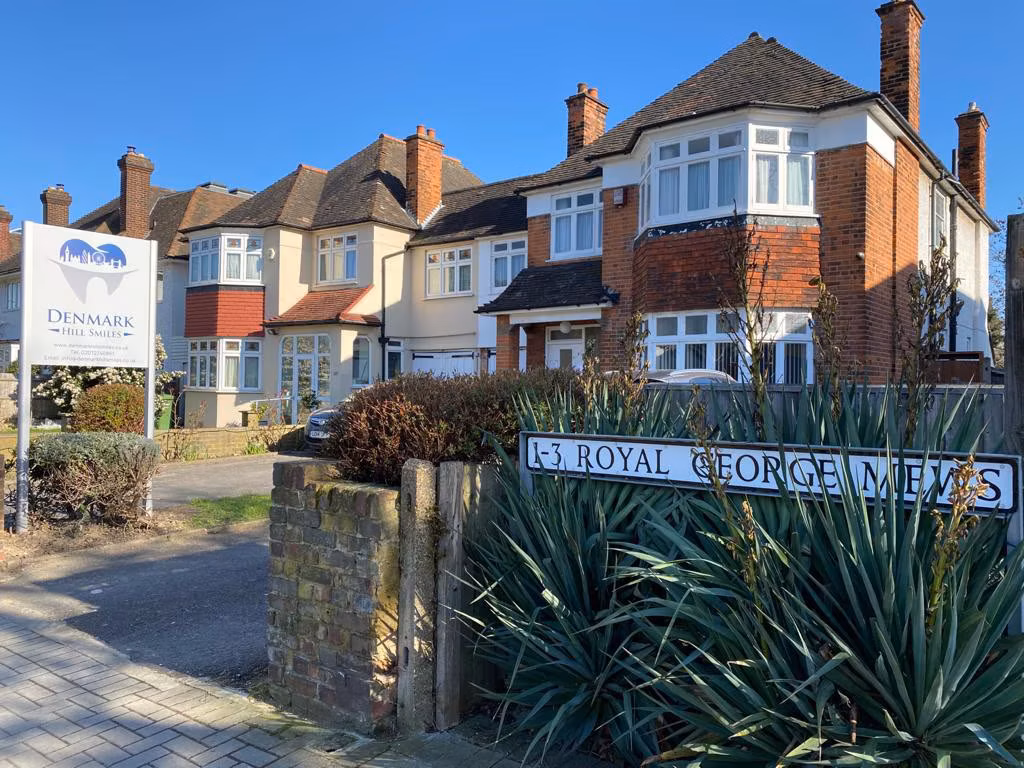 The exterior of Denmark Hill Smiles practice with its official sign displayed above the entrance.